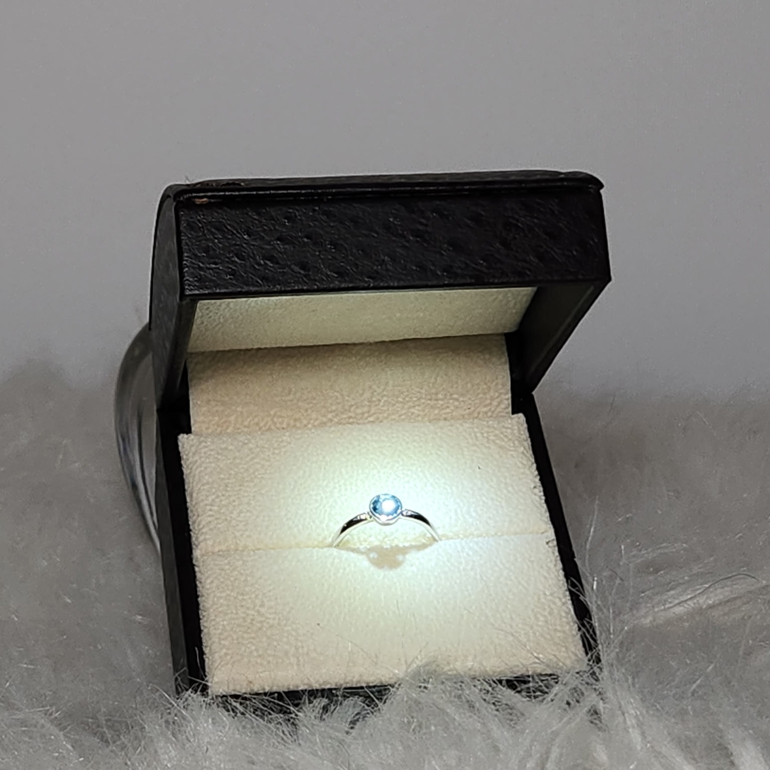 Angara Silver Ring With Light Blue Topaz